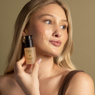 Blonde woman holding Tano Skincare Reformulate Serum