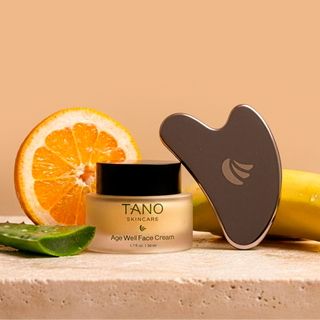 TANO skincare product with a gua sha tool and fruits on a beige background