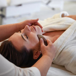 Person receiving a facial massage in a spa setting
